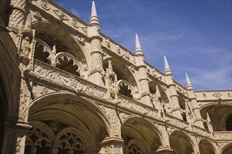 Old architectural building with arches and carved decorative sculptures in the inner courtyard at