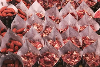 Cuts of ham and small sausages packed for sale, Mercado San Miguel market, Madrid city centre,