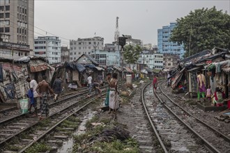 Father with his son walking on the railway tracks, Tejgaon Slum Area, Dhaka, Bangladesh, Asia