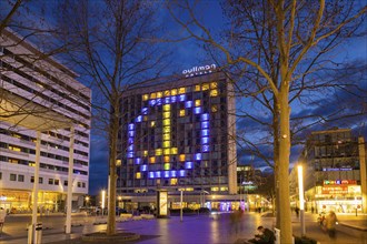 Light installation of a peace symbol as a protest against the Ukraine war at the Pullmanhotel on