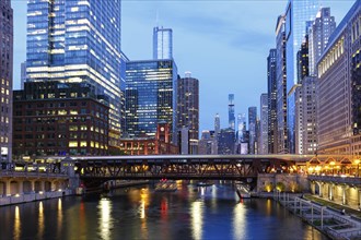 Skyline skyscrapers skyscrapers on the Chicago River bridge at night in Chicago, USA, North America