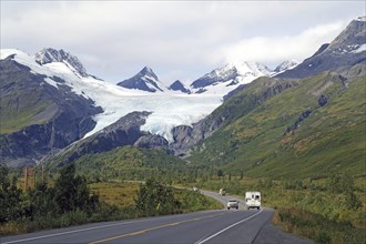 Autumn landscape, car driving towards a glacier calving deep into the valley, Worthington Glacier,