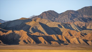 Dry mountains in the evening light, Toktogul reservoir, Jalalabad region, Kyrgyzstan, Asia