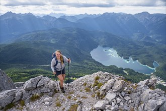 Hiker in the mountains, view of Eibsee lake and Werdenfelser Land, Wetterstein Mountains,