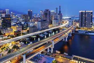 Kobe skyline from above with harbour and elevated roads at night in Kobe, Japan, Asia