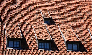 Tiled roof with four dormer windows, attic flat