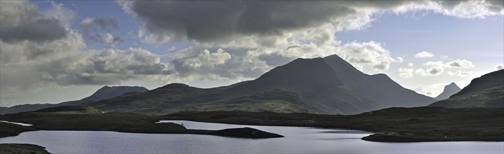 Highland scenery with loch and rain clouds at Assynt, Sutherland, Scotland, UK