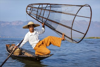 Myanmar travel attraction landmark, Traditional Burmese fisherman with fishing net at Inle lake in