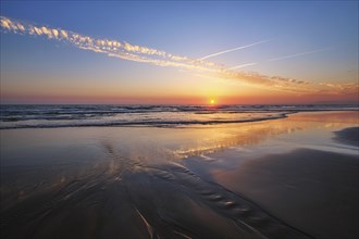 Atlantic ocean sunset with surging waves at Fonte da Telha beach, Costa da Caparica, Portugal,