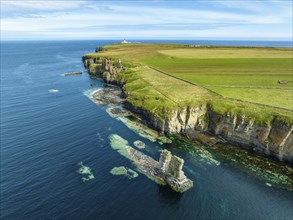 Rugged rocky landscape on the North Sea coast with the ruins of Girnigoe and Sinclair Castle, Wick,