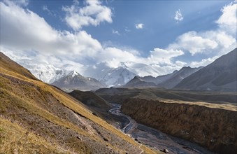 Valley with river Achik Tash between high mountains, mountain landscape with glaciated peak Pik