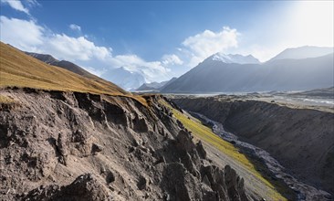 Valley with river Achik Tash between high mountains, mountain landscape with glaciated peak Pik