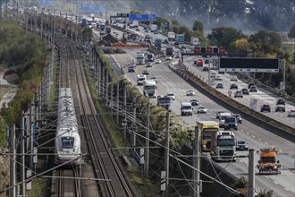 A Deutsche Bahn ICE train passes cars on the A3 motorway, Flörsheim, 28/09/2020