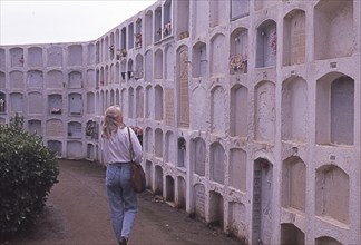 Woman visits burial site in Calella, Costa Brava, Barselona, â€‹â€‹Catalonia, Spain, Southern