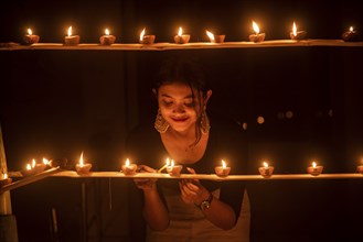 Students of Cotton University lighting diya (Clay lamp) on the occasion of Diwali Festival, on