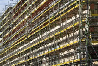 Large construction site, scaffolded shell of an office and commercial building complex, Bochum