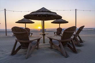 Beach restaurant, furniture on the beach of Scheveningen, sunset, Netherlands