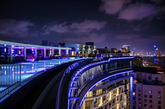 Night shot rooftop pool, swimming pool, Dubai Marina skyline behind, Hotel NH Collection The Palm