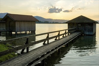 Boat huts with wooden jetty, sunset at Lake Kochel near Kochel am See, Bavarian Alpine foothills,