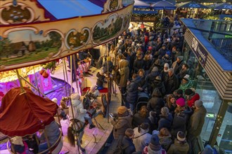 Historic horse-drawn carousel at the Christmas market on the Heumarkt in the old town of Cologne,