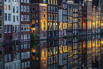 Canal houses on the Damrak, in the centre of the old town of Amsterdam, harbour, starting point of