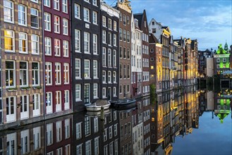 Canal houses on the Damrak, in the centre of the old town of Amsterdam, harbour, starting point of