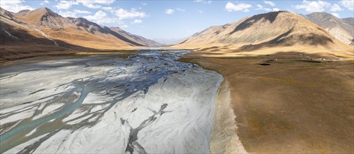 Aerial view, Burkhan mountain valley with meandering river, barren dramatic mountain landscape,