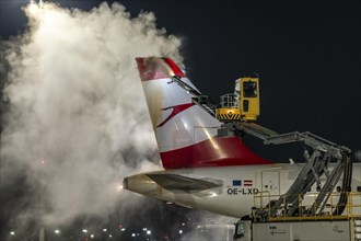 Winter at Frankfurt Main Airport, FRA, Austrian aircraft being de-iced by de-icing vehicles, Hesse,