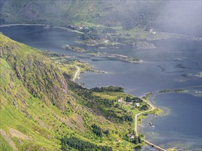 View from top of mountain Justadtinden towards east over Rolvsfjorden, road no. 815, island