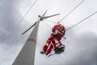 Height rescuers from the Oberhausen fire brigade practise abseiling from a wind turbine from a