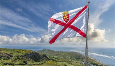 The flag of the Isle of Jersey, Great Britain flutters in the wind