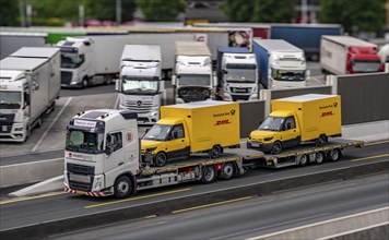 Car transporter with 2 new delivery vehicles for Deutsche Post, DHL, electric vehicles, on the A2