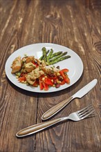 Spicy chicken stew with vegetables and fried asparagus