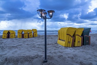 End of the season on the beach, dark storm clouds, choppy sea, autumn on the North Sea in North