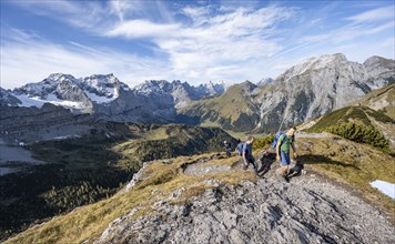 Two mountaineers on a hiking trail, mountain panorama with rocky steep peaks, view of summits