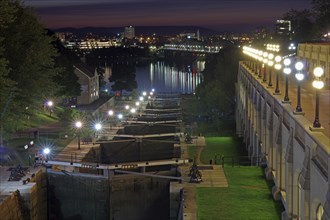 Night scene of a city on a river with illuminated locks and buildings, Rideau Canal, Ottawa,