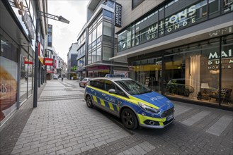 Effects of the coronavirus crisis, empty shopping street, patrol from the public order office and