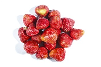 Pile of red strawberry isolated on white background. Top view