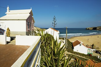 Colourful holiday homes and beach, Monte Clérigo, Atlantic coast, Algarve, Portugal, Europe