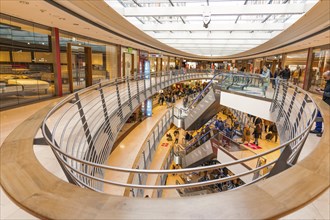 Modern interior design of a shopping centre with curved wooden railings, Königsbau Passagen