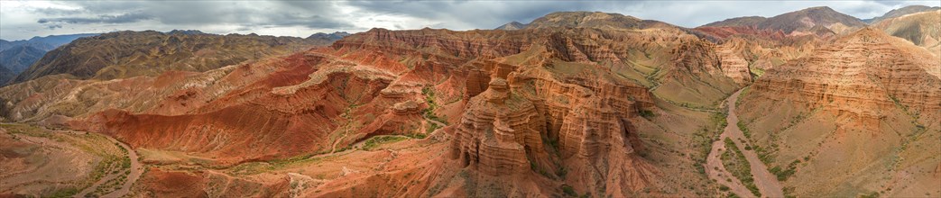 Eroded mountain landscape, canyon with red and orange rock formations, aerial view, Konorchek