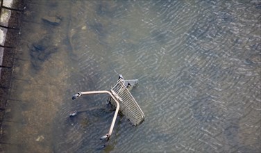 Shopping trolley thrown into River Gipping, Ipswich, Suffolk, England, United Kingdom, Europe