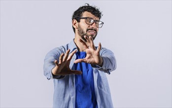 Young man with rejection expression isolated. Man with scared expression on his face making