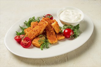 Fried fish nuggets, with white sauce, arugula and cherry, no people