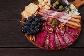 Appetizer, assortment, set, sausage, and cheese, on a wooden board, top view, no people