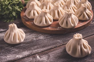 Raw khinkali, Traditional Georgian dish, on a wooden table, selective focus, rustic, no people