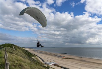 Paragliders along the dunes of Zoutelande, in Zeeland, South Holland, Netherlands