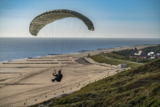 Paragliders along the dunes of Zoutelande, in Zeeland, South Holland, Netherlands