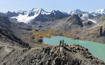 Hiker at the pass at 4000m, aerial view, mountains with glacier, mountain pass and mountain lake