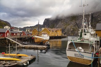 Historic buildings and fishing boats in the harbour of Nusfjord, Lofoten, Nordland, Norway, Europe